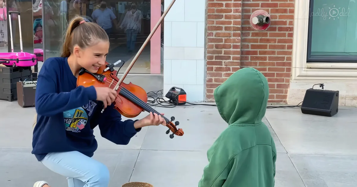 little boy kisses street violinist Karolina Protsenko