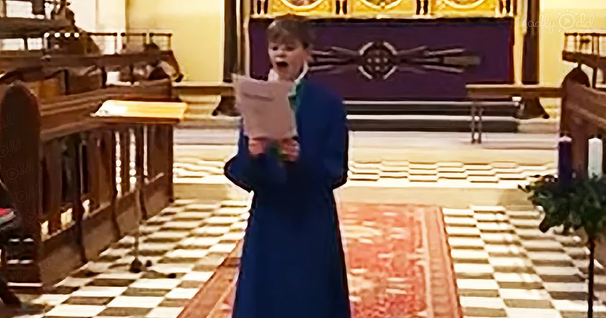 A person in a blue robe stands in a church, holding a piece of paper, with a checkered floor and altar in the background.