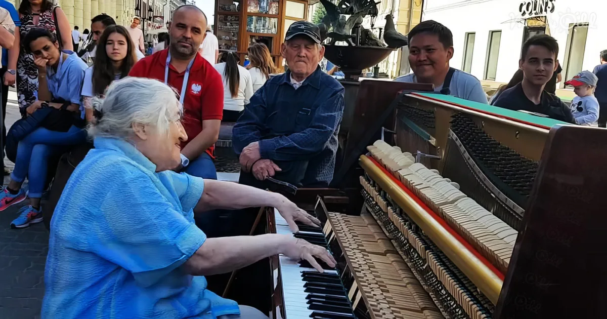Senior woman playing street piano