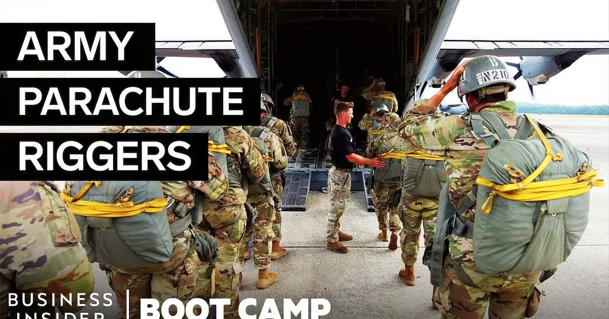 Soldiers in a helicopter prepare for a jump, wearing gear and looking out the open door.