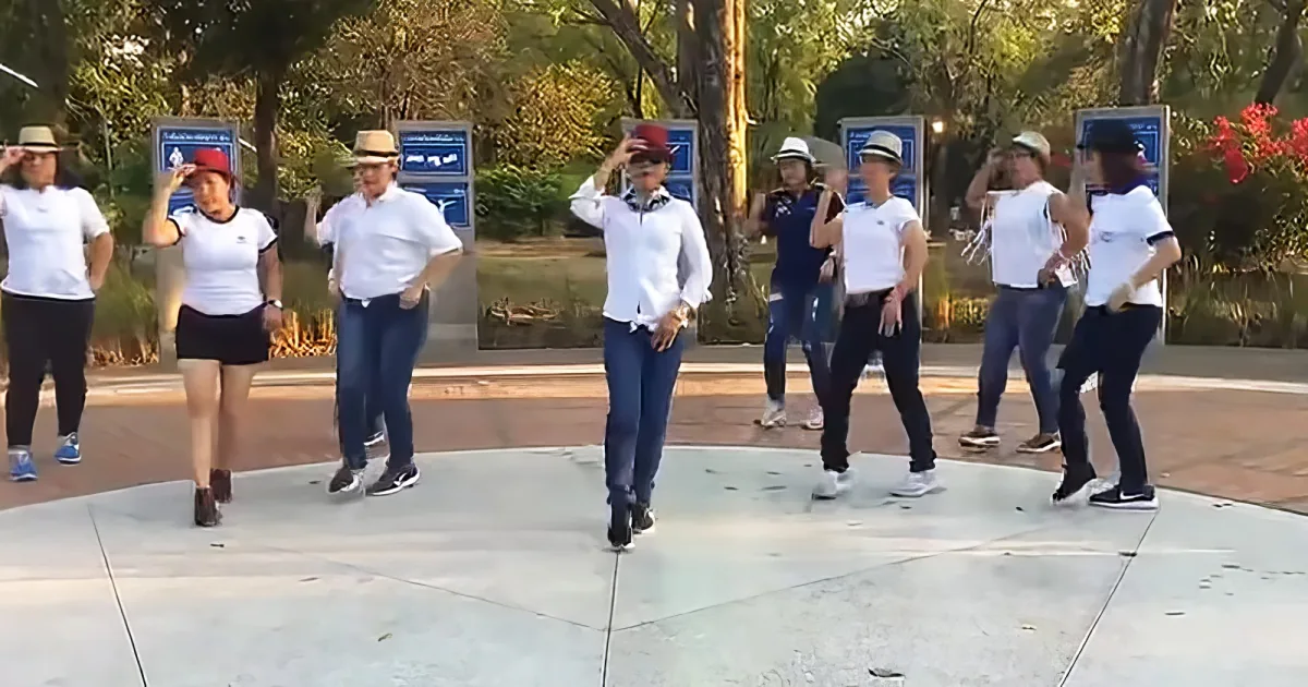 Nine women performing catchy line dance