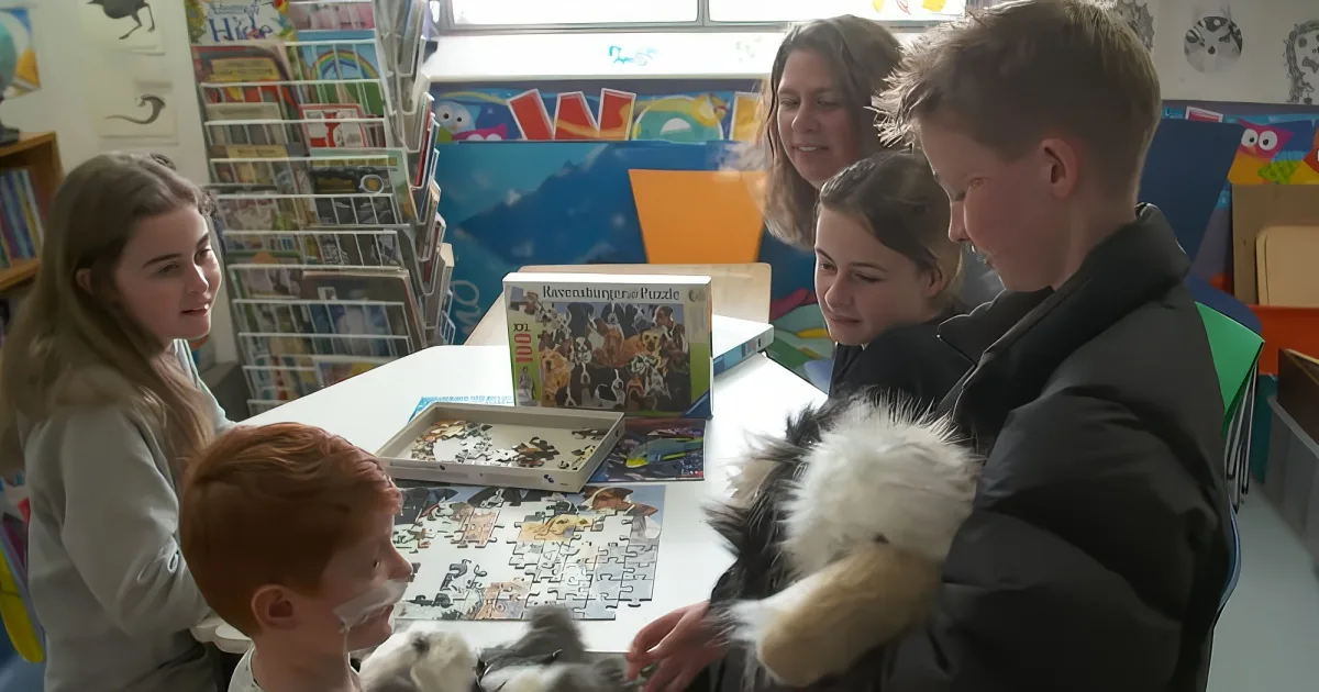 Children and adults work together on a puzzle in a colorful classroom setting.