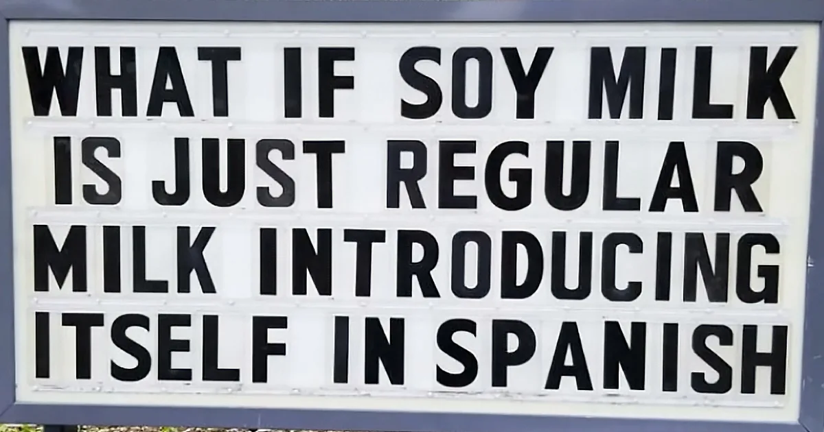 A sign humorously suggests soy milk is just regular milk in Spanish.