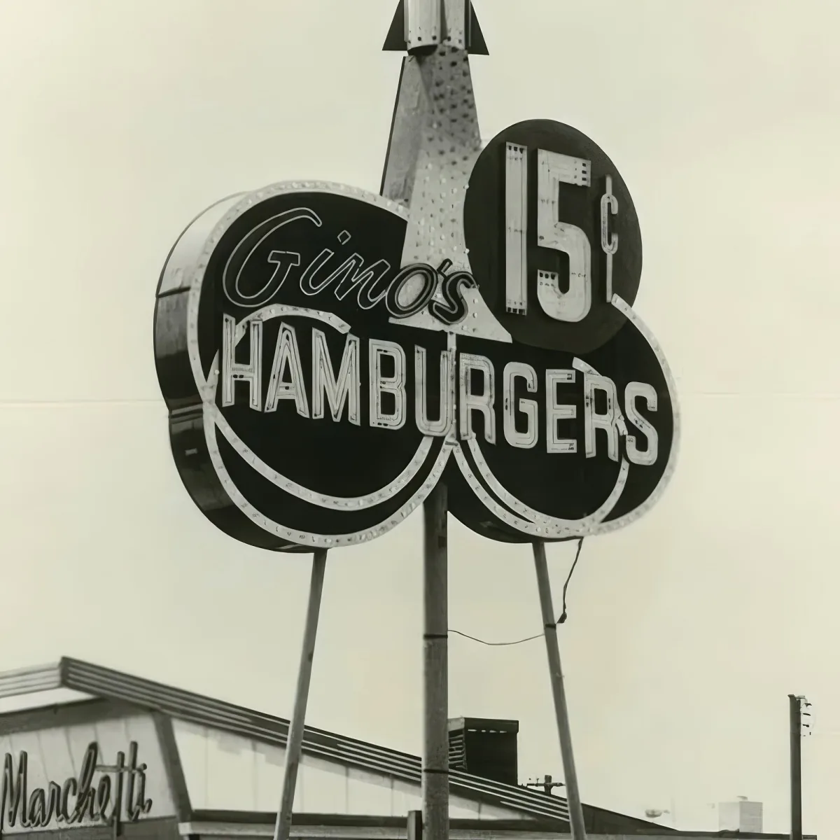 A vintage sign advertises "Gino's Hamburgers" with a price of 15 cents.