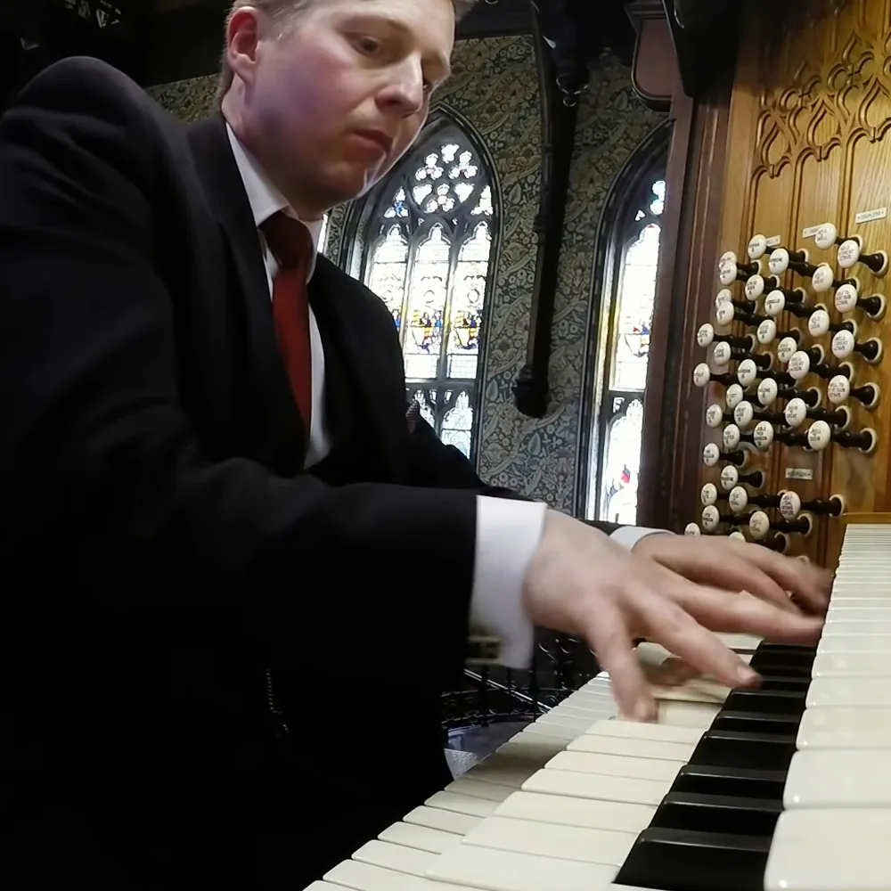 Man playing pipe organ