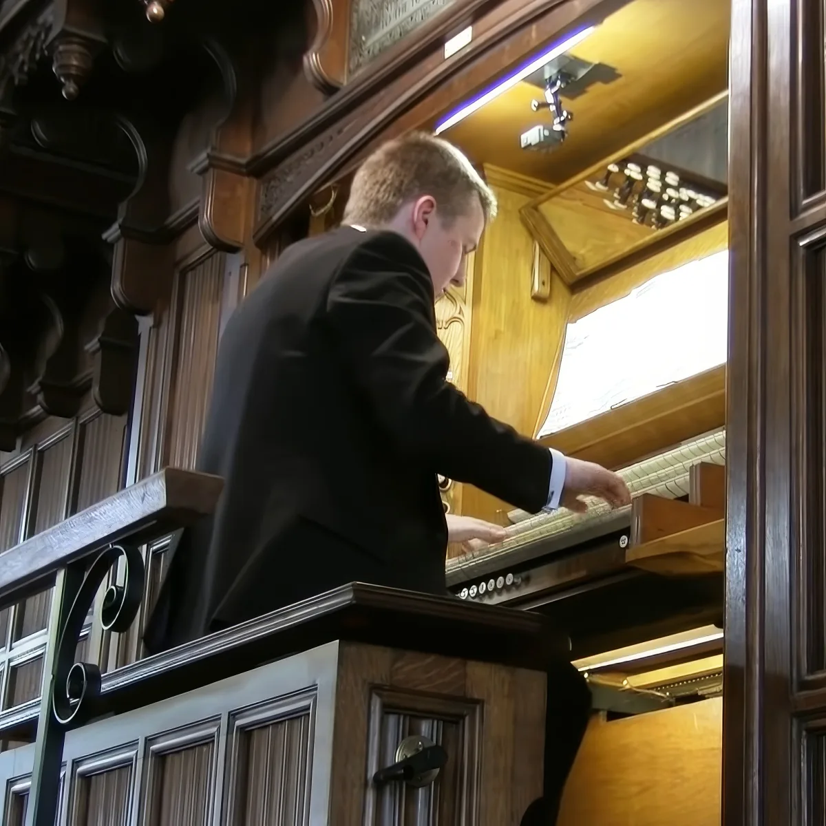 Man playing pipe organ