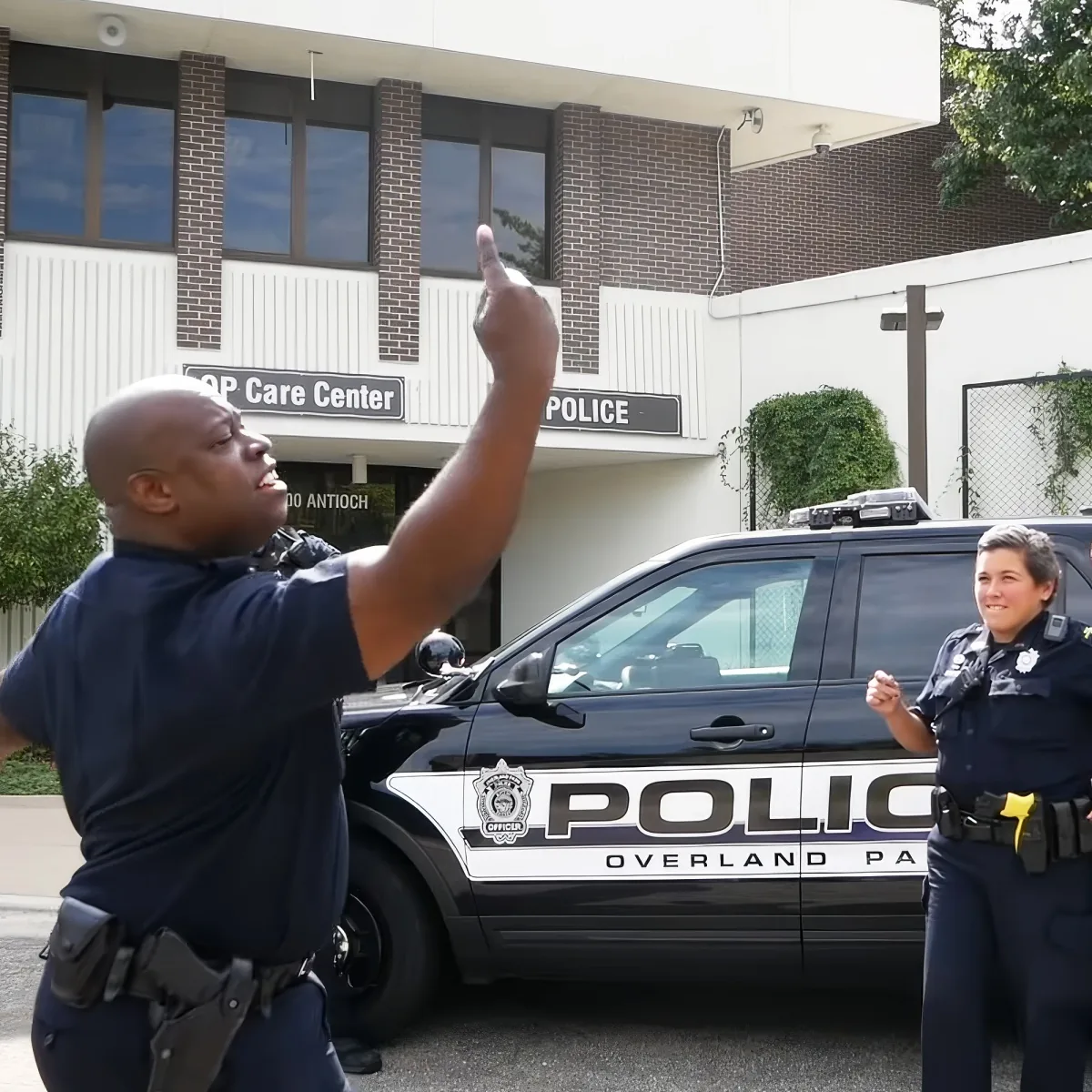 A police officer in Overland Park, Kansas, gestures while standing next to a patrol car.