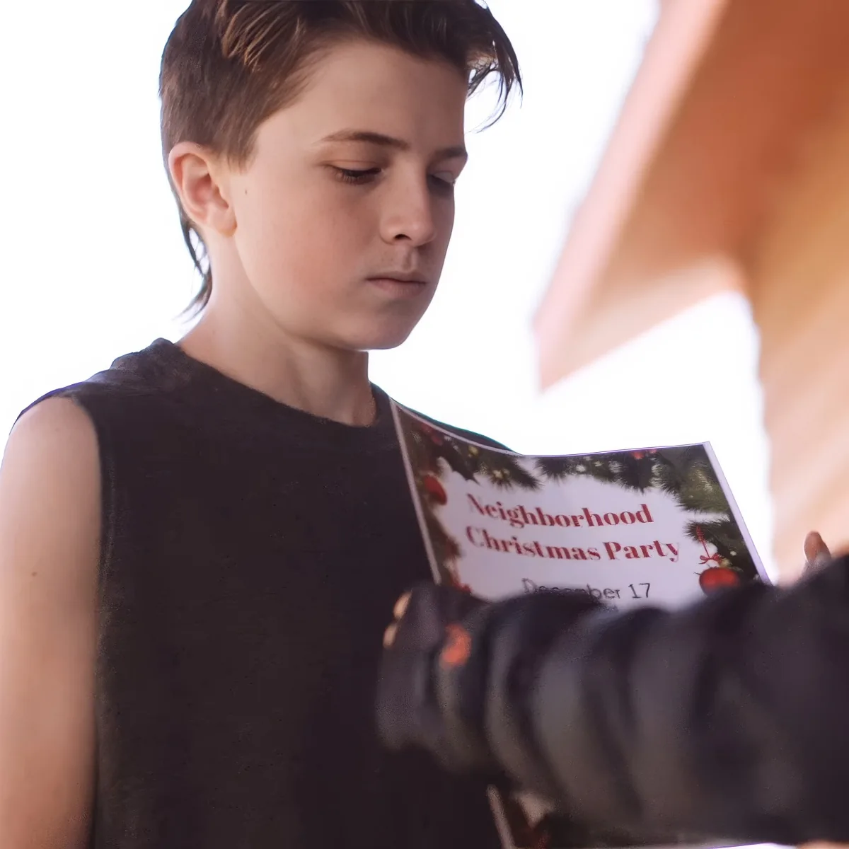 Boy giving Christmas party flyer