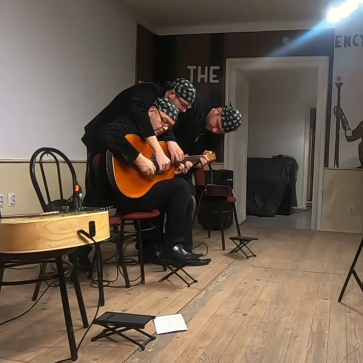 Three men playing guitar