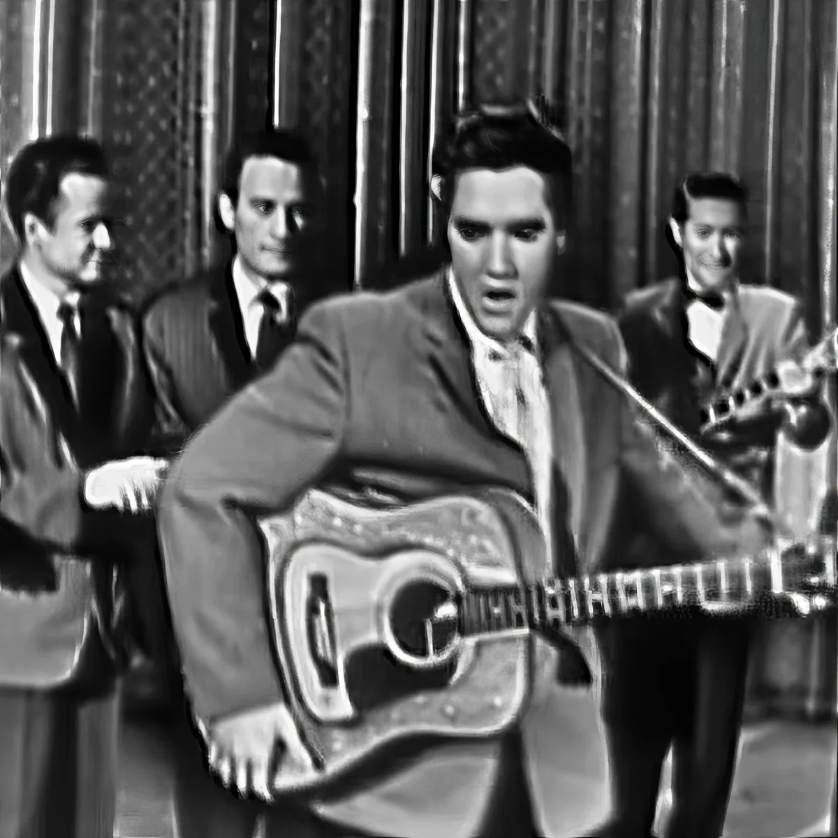 Elvis Presley plays guitar passionately on stage with band behind him.