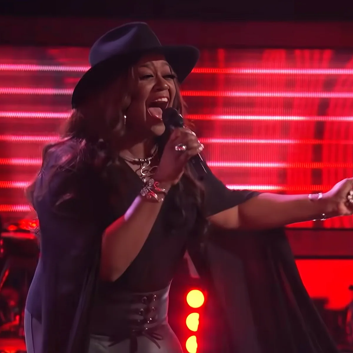 Female singer singing on "The Voice"