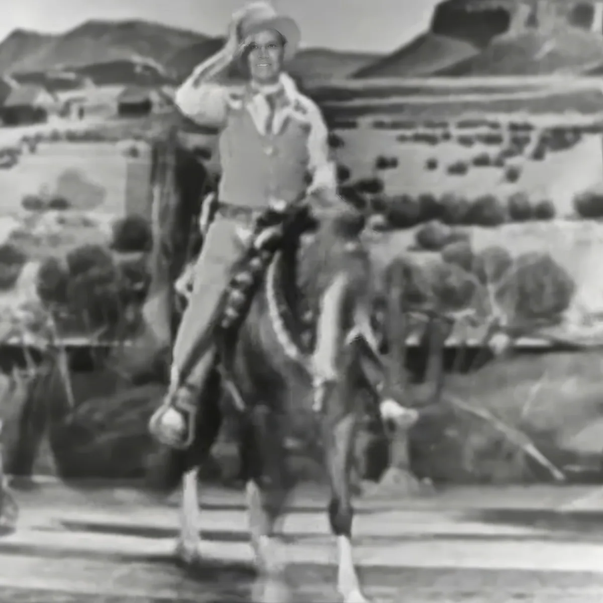 A cowboy on horseback salutes, with a desert landscape and cacti in the background.