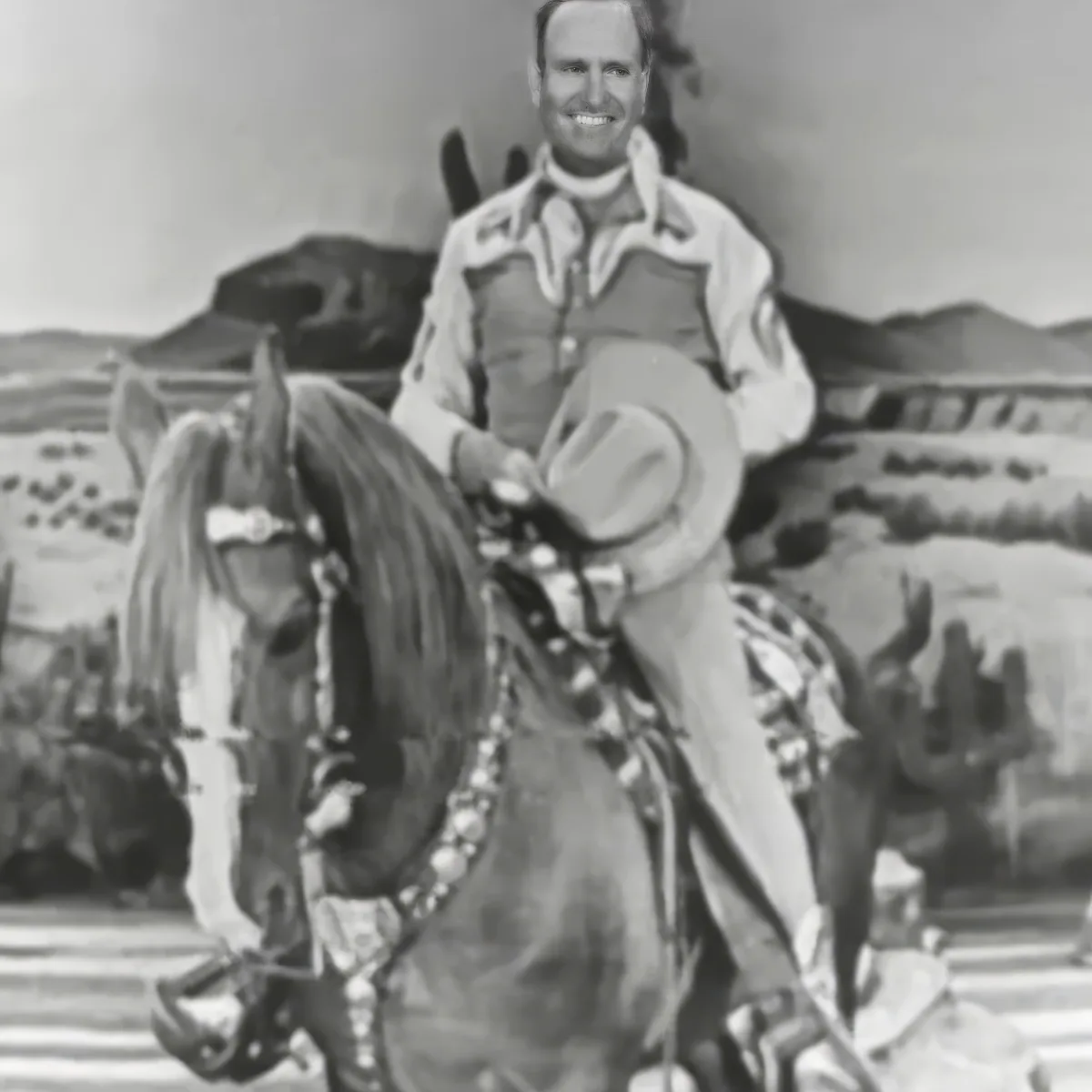 A man in a cowboy outfit smiles while riding a horse in a desert landscape.
