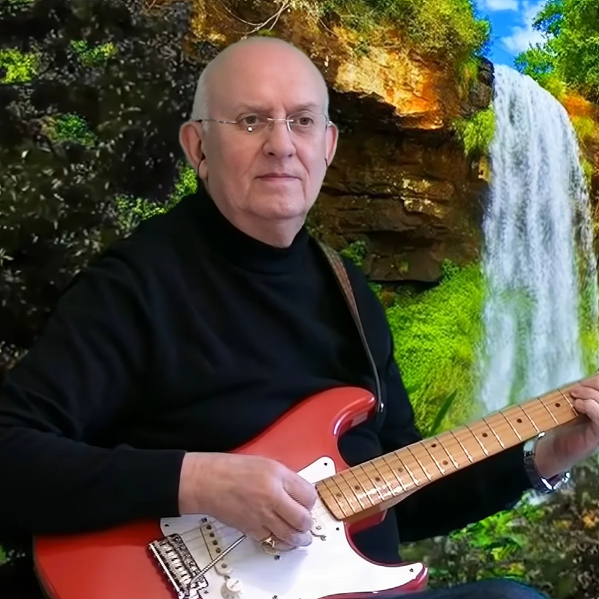 A man in a black turtleneck plays a red electric guitar in front of a scenic waterfall backdrop.