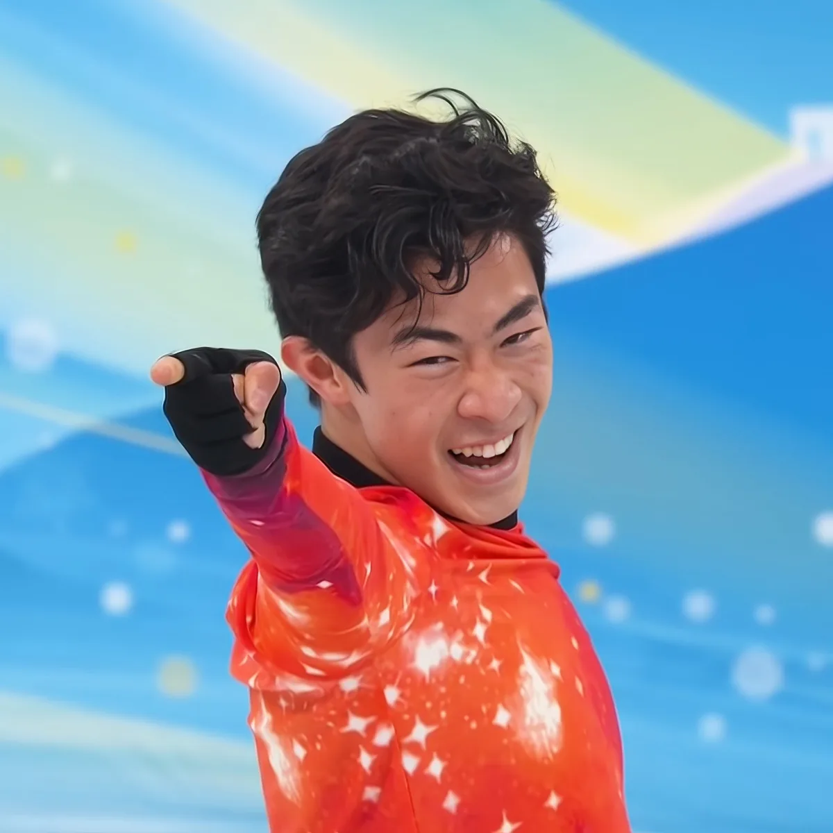 A person in a red outfit celebrates with a fist pump, smiling broadly, against a colorful, abstract background.