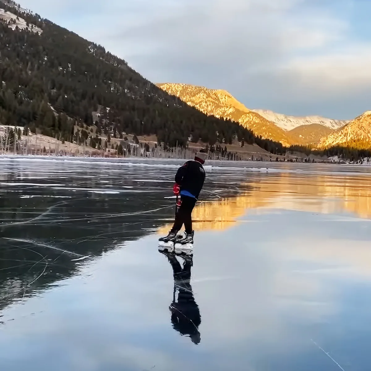 Kids practicing hockey on a frozen Lake