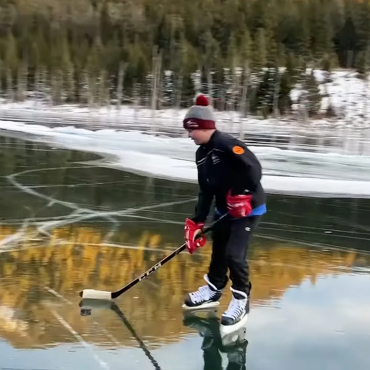 Kids practicing hockey on a frozen Lake