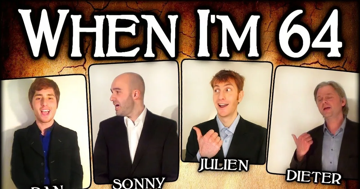 Four men in suits, one pointing, all with expressive faces, against a plain background.