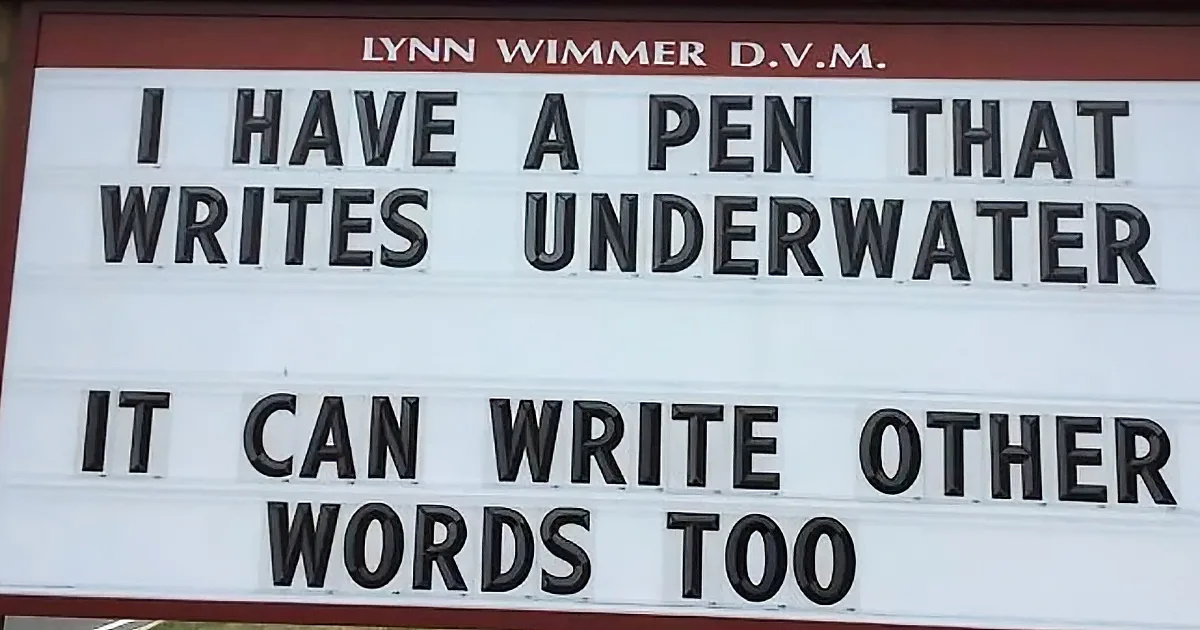 A sign advertises Lynn Wimmer, D.V.M., with a humorous message about a pen that writes underwater.