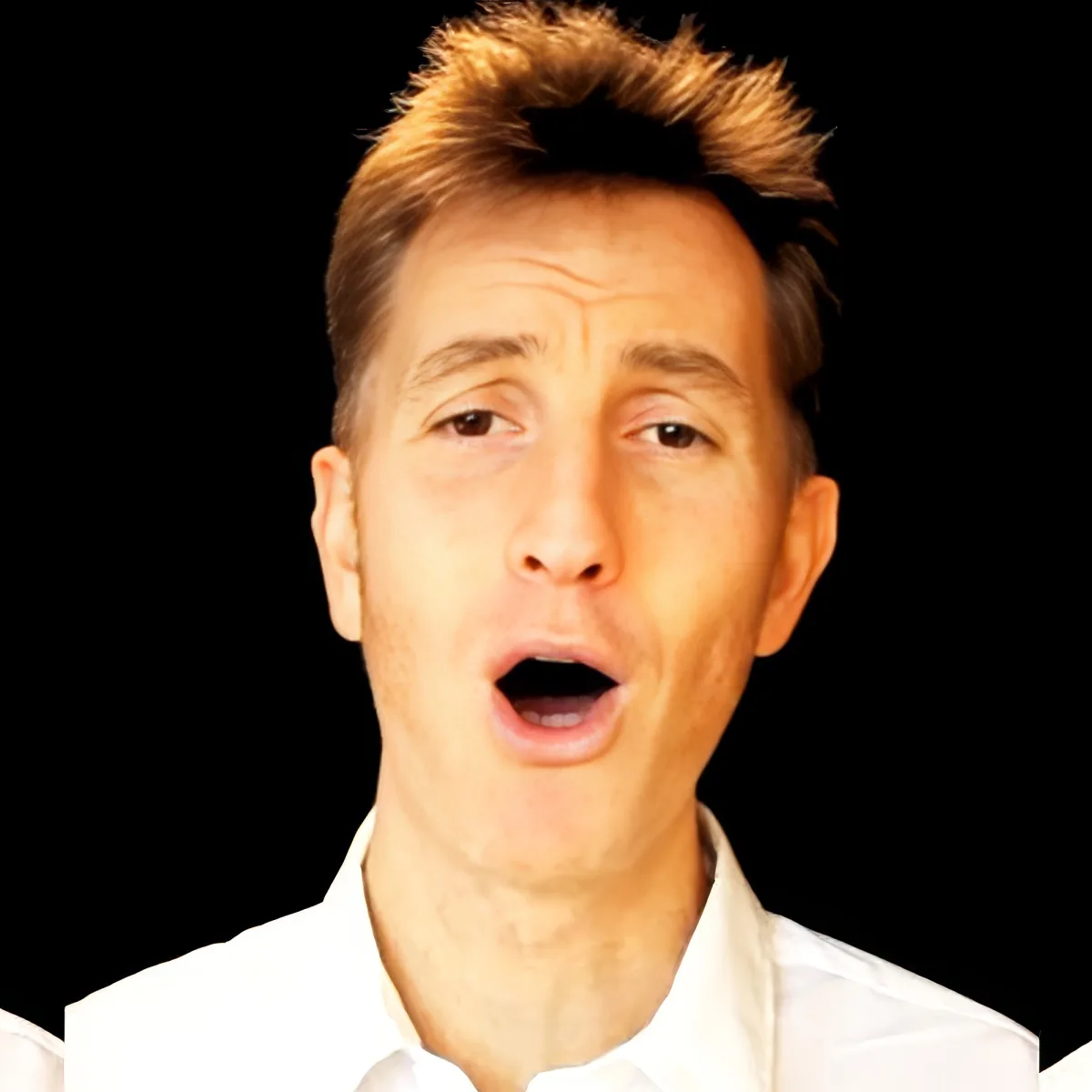 A man with light brown hair, wearing a white shirt, appears surprised or shocked.