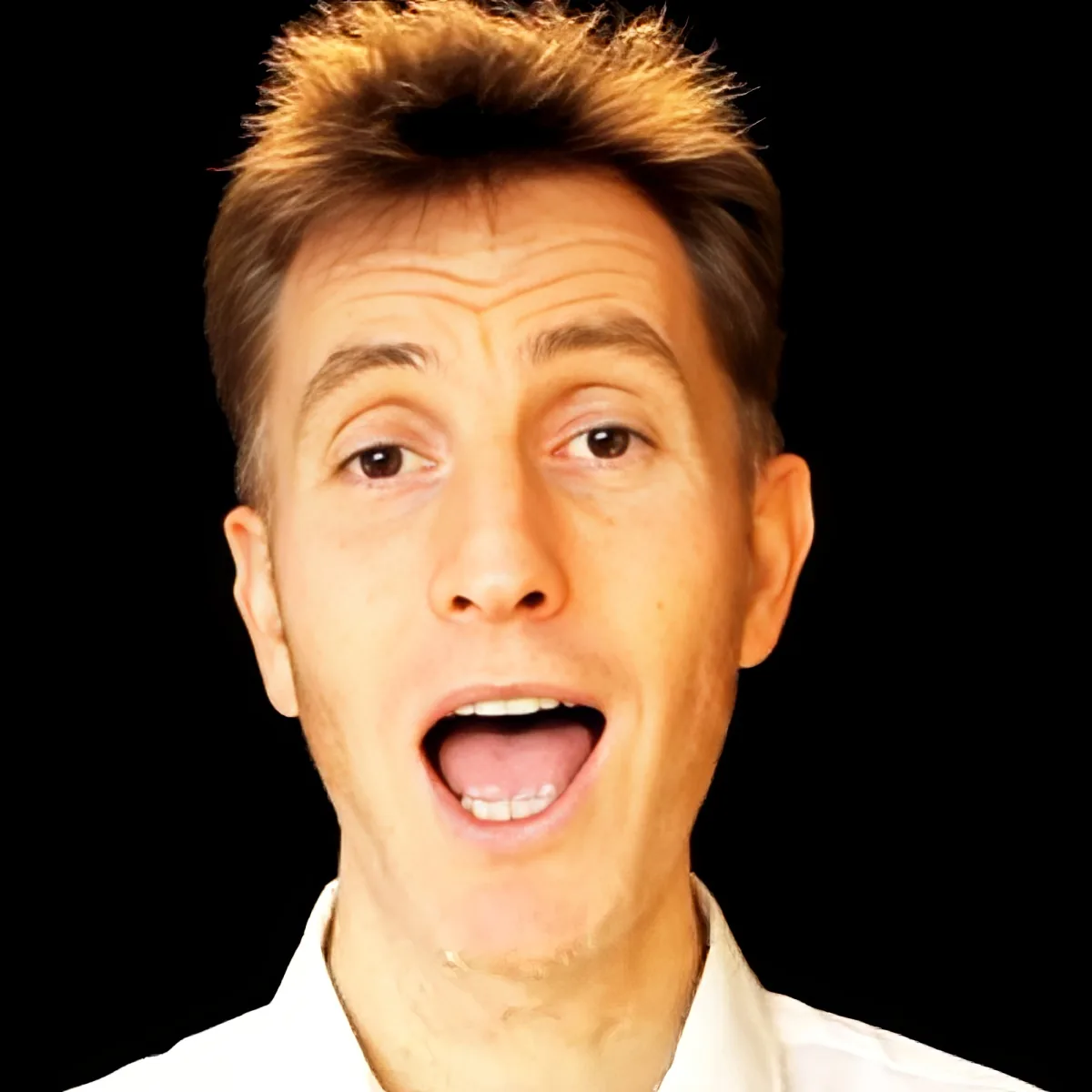 A man with short, spiky hair and a white shirt is making a surprised or excited expression.