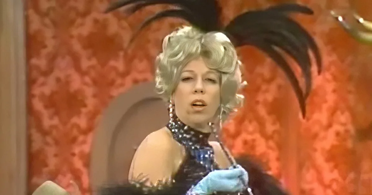 A woman in a glamorous outfit with a feathered hat and a blue glove is the main subject.