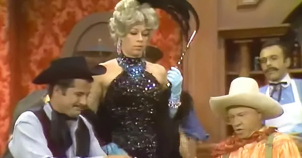A woman in a sequined dress and hat stands, holding a cane, surrounded by men in Western attire.