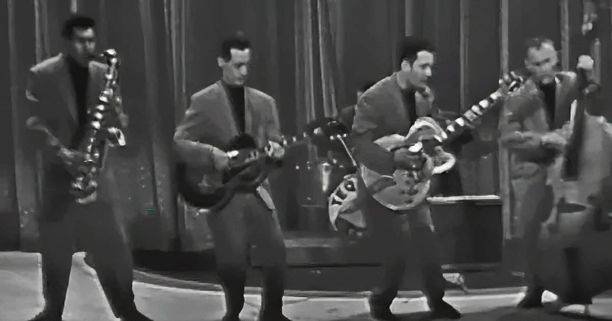 A saxophonist leads a band playing guitars and a bass in a vintage black-and-white setting.