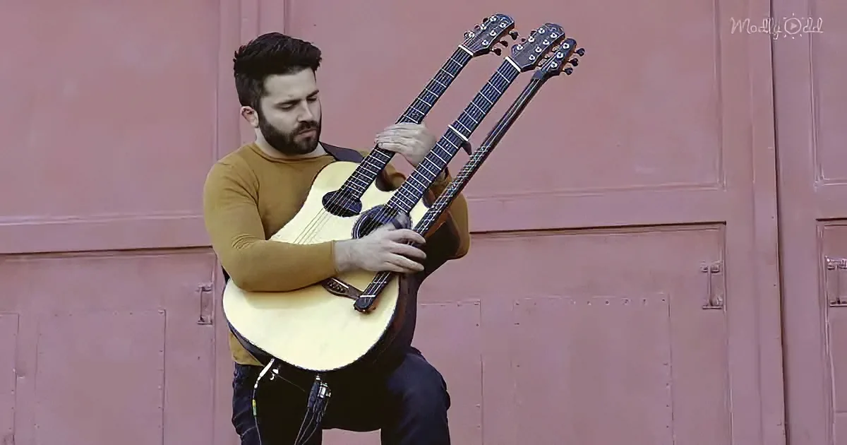 A man plays two guitars simultaneously, demonstrating skill and multitasking.