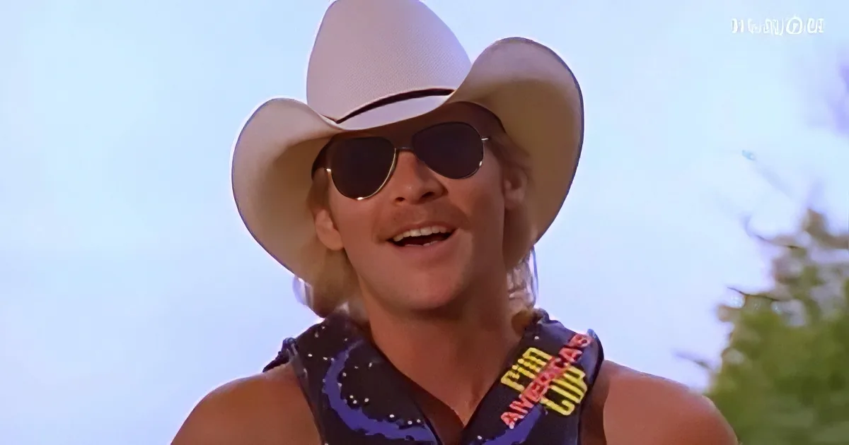A person wearing a white cowboy hat, sunglasses, and a bandana with "CIM" and "AMERICAS" visible, smiling outdoors.