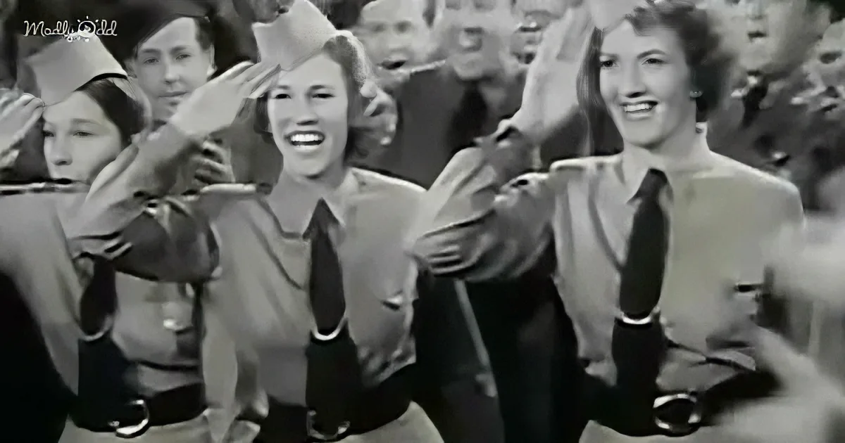Women in uniform saluting, smiling, and cheering in a crowd.