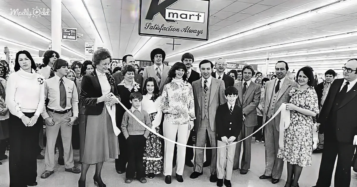 A woman cuts a ribbon at a Kmart store opening, surrounded by a crowd of people.