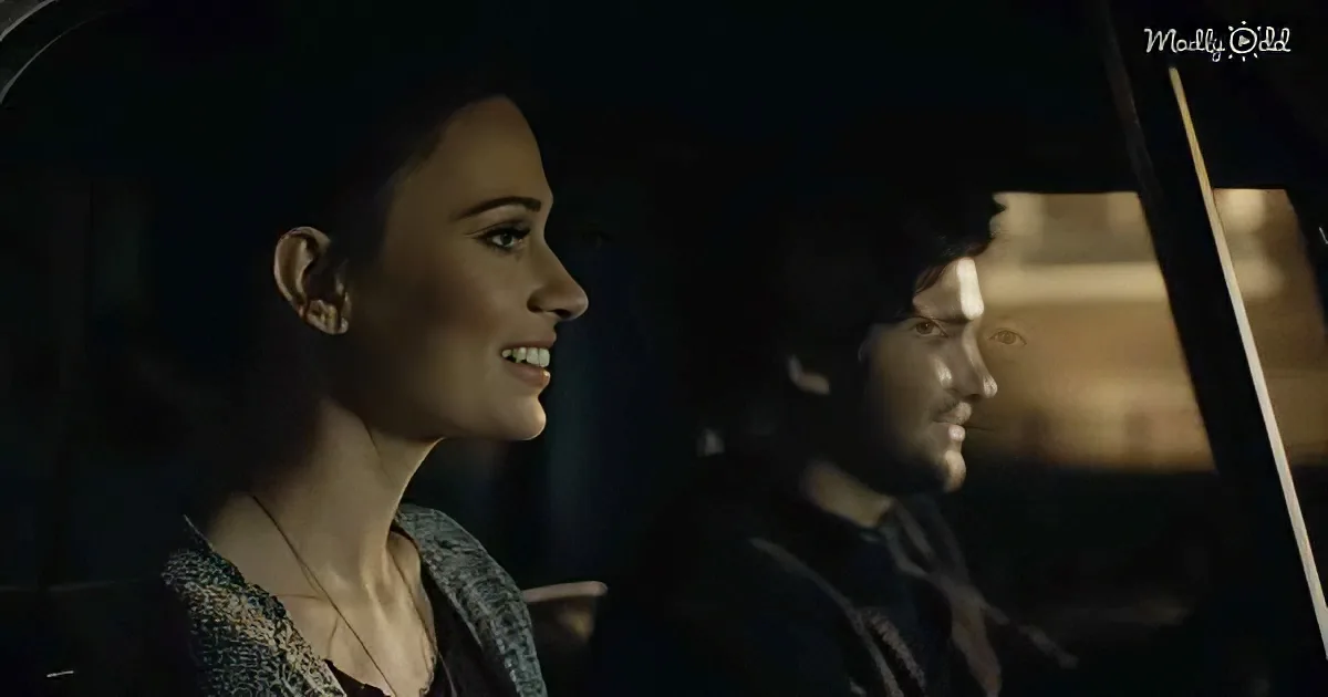 A woman smiles warmly, sitting in a car with another person, both appearing relaxed and engaged.