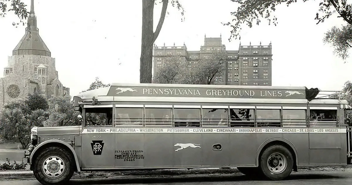 A vintage Pennsylvania Greyhound Lines bus is parked, displaying route destinations on its side.