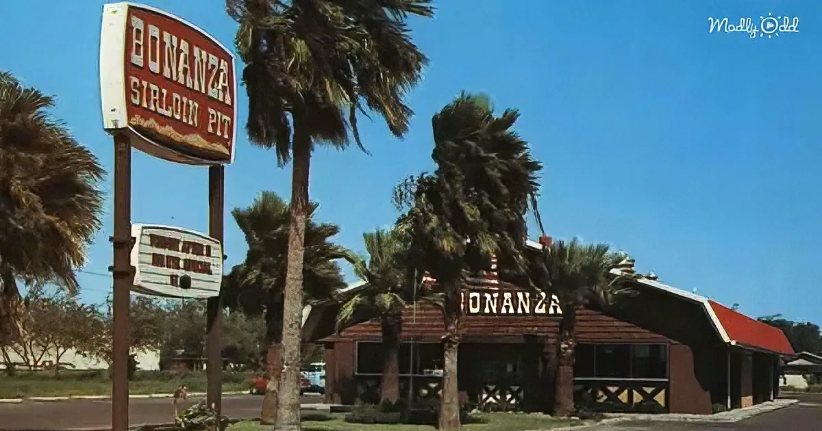 Bonanza Sirloin Pit sign stands tall with palm trees and restaurant in the background under a clear blue sky.