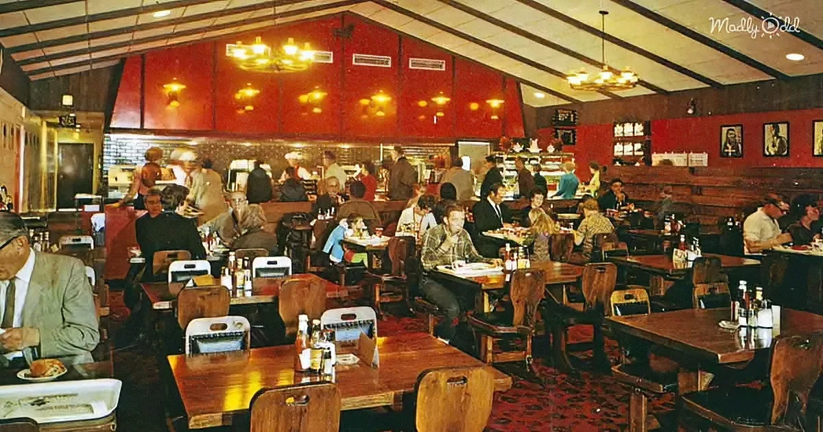 A bustling diner with wooden tables, red walls, and patrons enjoying meals and drinks.