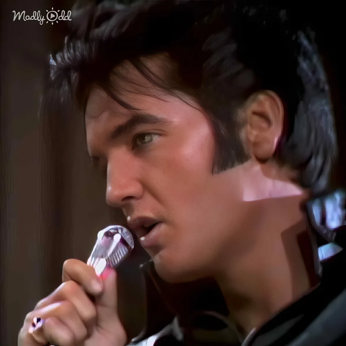 A man with dark hair and a cigarette in his mouth, looking to the side.