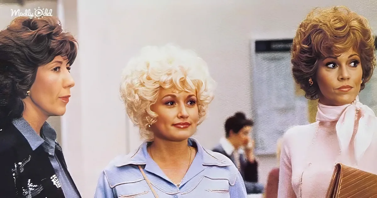 Dolly Parton stands between two women in a scene from "9 to 5," with a blonde woman on her right and another woman on her...