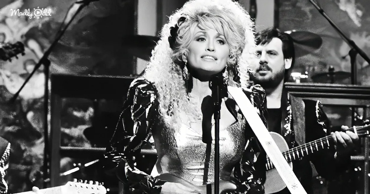 A woman with voluminous hair and a fur-trimmed outfit sings into a microphone, accompanied by a guitarist.