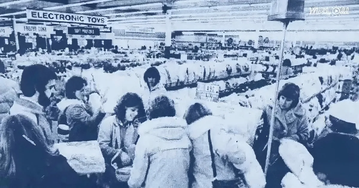 Crowded store with people shopping, sign reads "Electronic Toys," busy atmosphere.