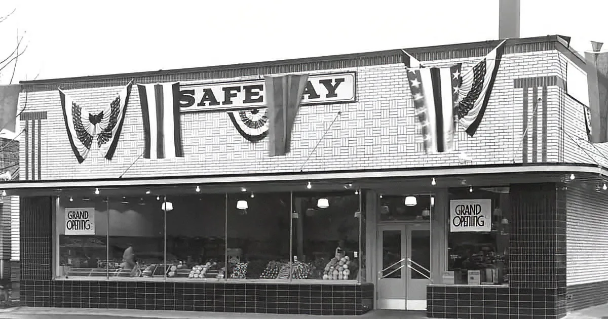 A Safeway store with patriotic decorations and "Grand Opening" signs in the windows.