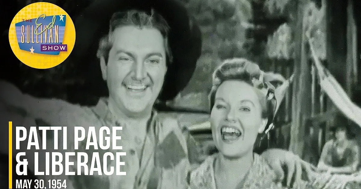 A man in a cowboy hat and a woman in a dress smile joyfully in a black-and-white scene.