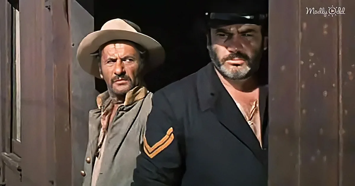 Two men, one in a cowboy hat and the other in a military uniform, stand side by side, looking serious.