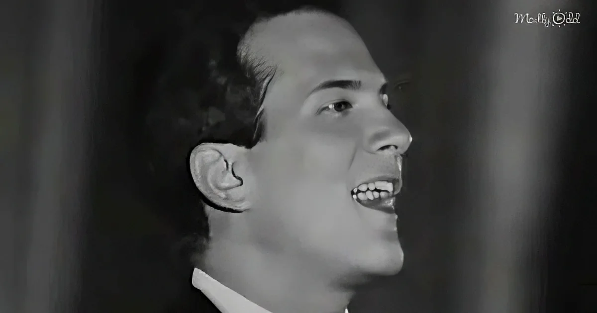 A man with a receding hairline and a white shirt is smiling and looking upwards.