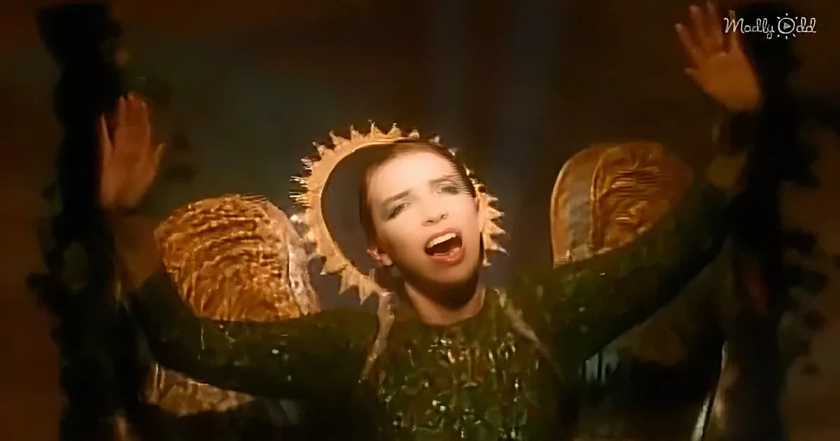 A person in a green outfit with a halo-like headpiece raises their arms in a dramatic pose.