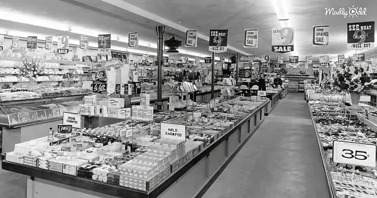A vintage grocery store aisle with shelves stocked with products, price signs, and promotional banners.