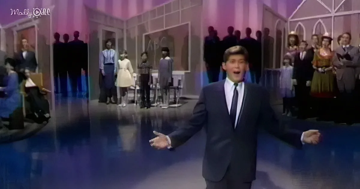 A man in a suit sings on stage with a backdrop of silhouetted people.