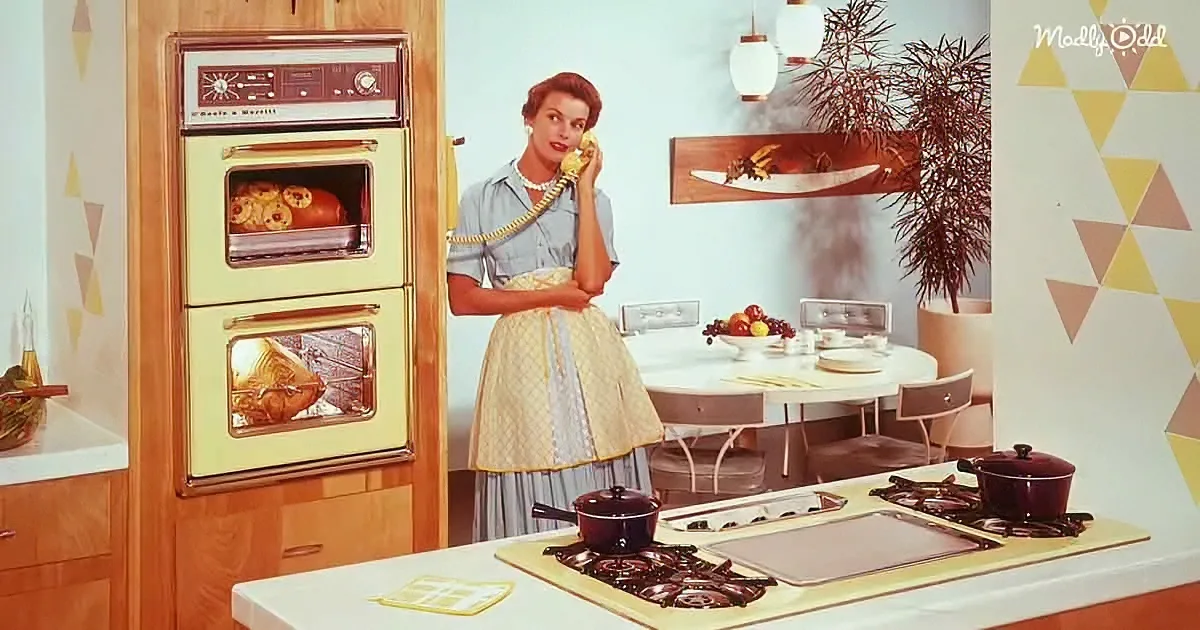 A woman in a 1950s kitchen talks on the phone, surrounded by vintage appliances and decor.