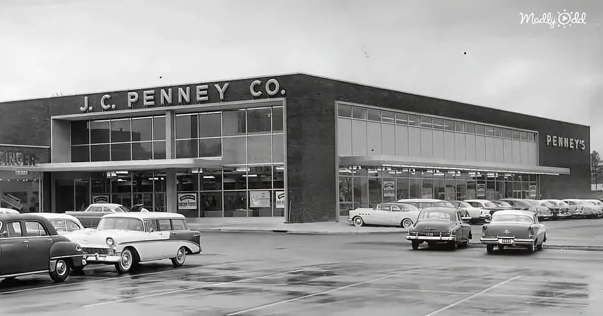 J.C. Penney Co. store with vintage cars parked in front, black-and-white photo.