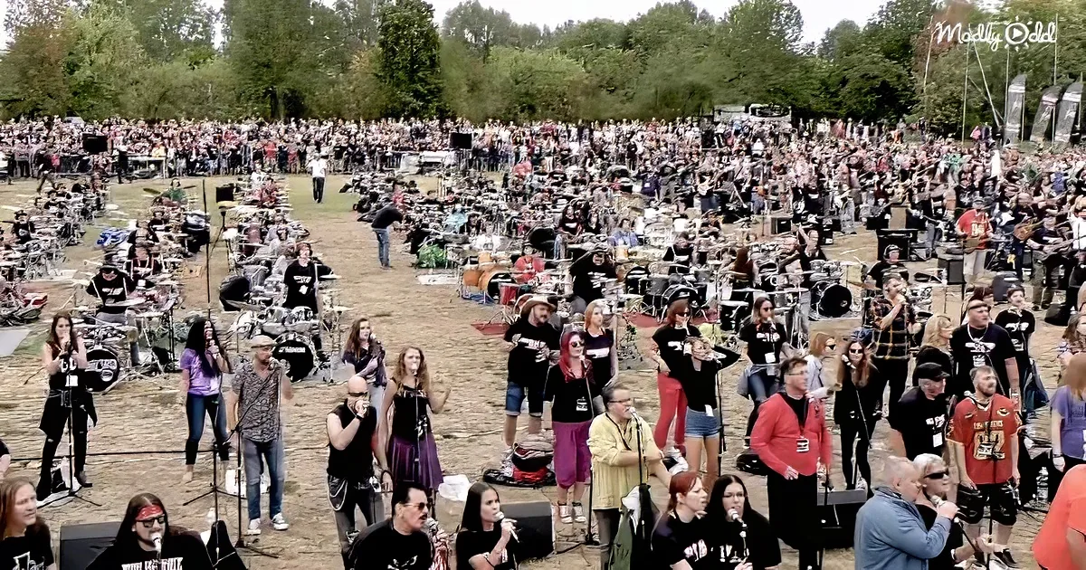 A large outdoor drum circle with a crowd watching and participating.